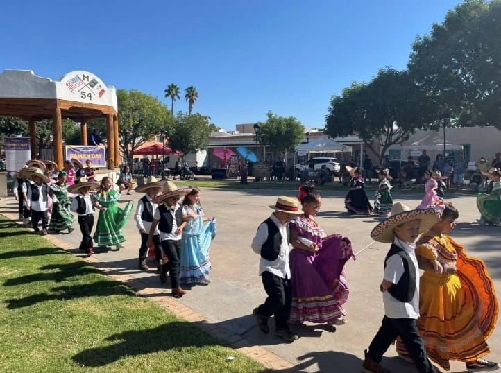 Children in Mexican attire dance at a Las Cruces cultural celebration, showcasing the spirit of local August events.