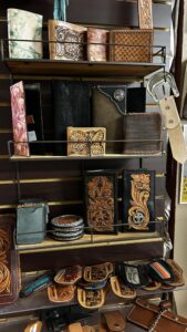 High Noon Leather handcrafted wallets and accessories displayed on shop shelves in Las Cruces, NM.