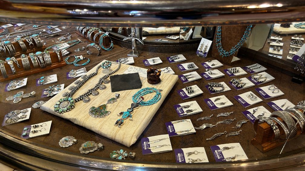 Silver Assets Mesilla display case with turquoise and silver necklaces, bracelets, rings, and earrings in Las Cruces, NM.